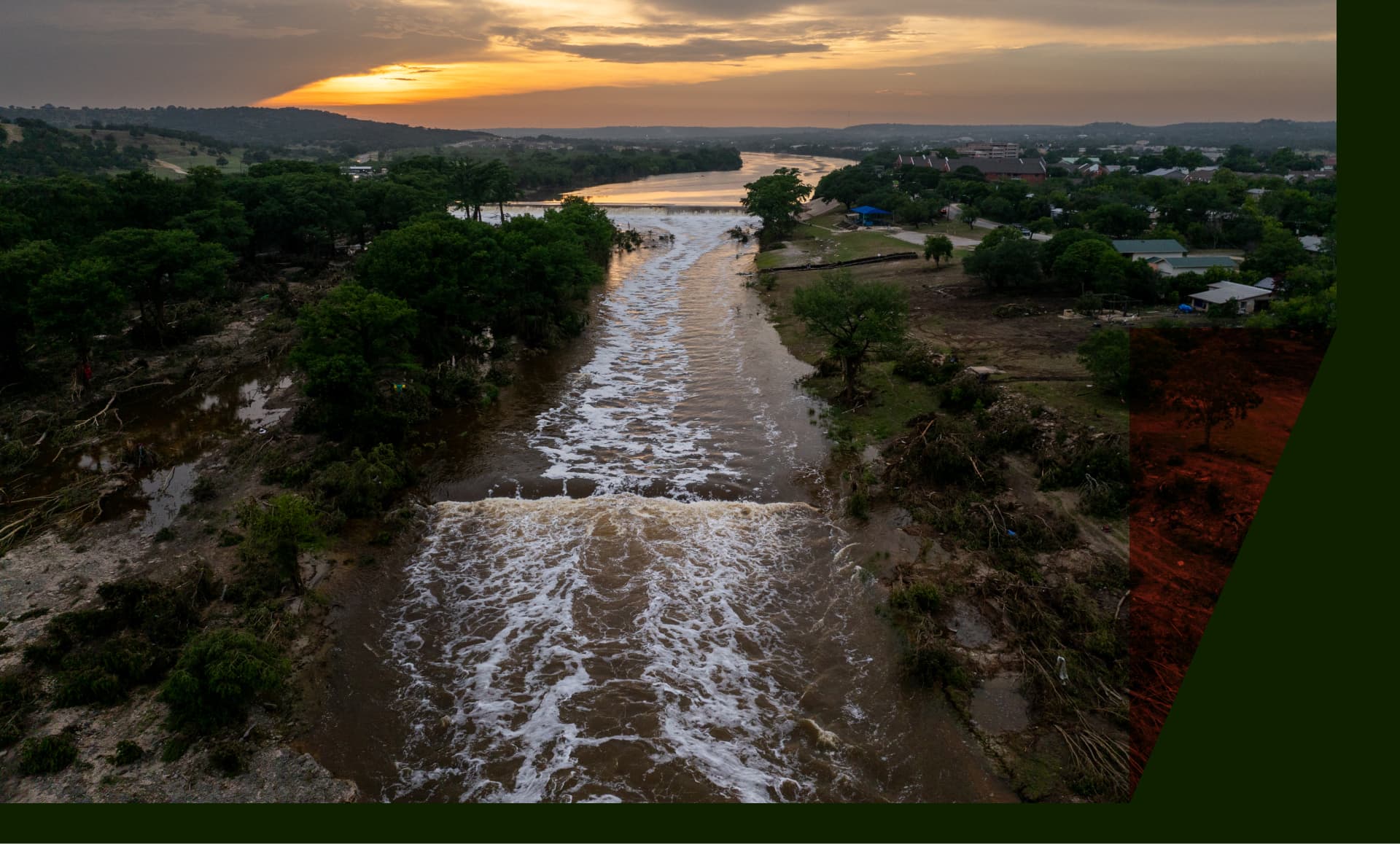 In an aerial view, the sun sets over the Guadalupe River