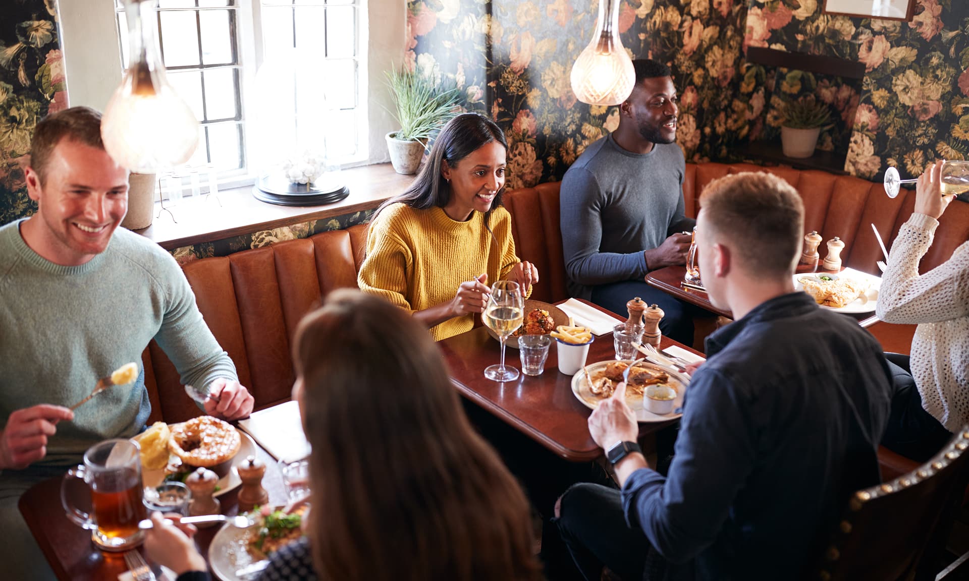 Woman sitting at table talking to man