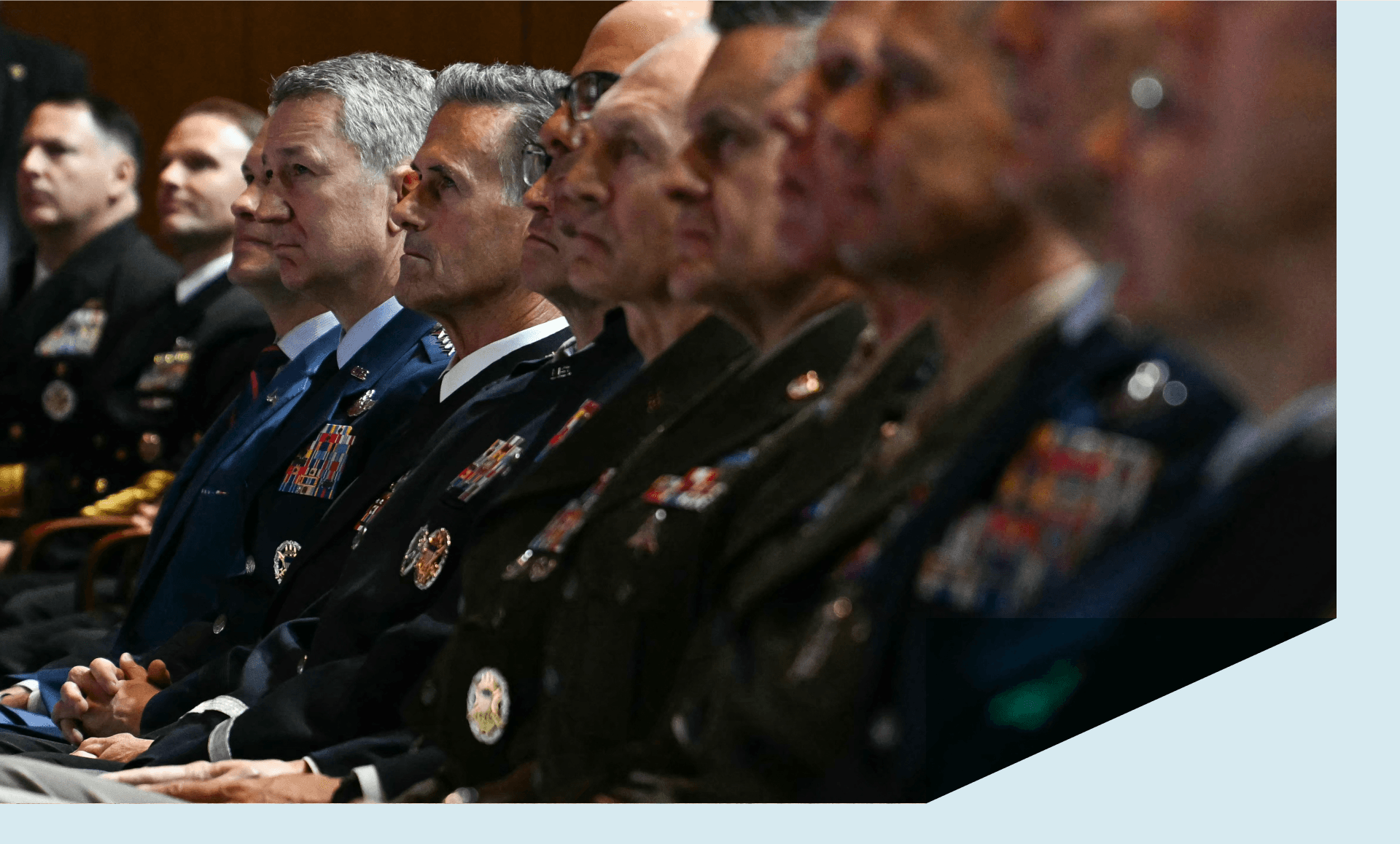 Military leaders, including Chairman of the Joint Chiefs of Staff Dan Caine (3L), listen as US President Donald Trump addresses senior military officers gathered at Marine Corps Base Quantico in Quantico, Virginia
