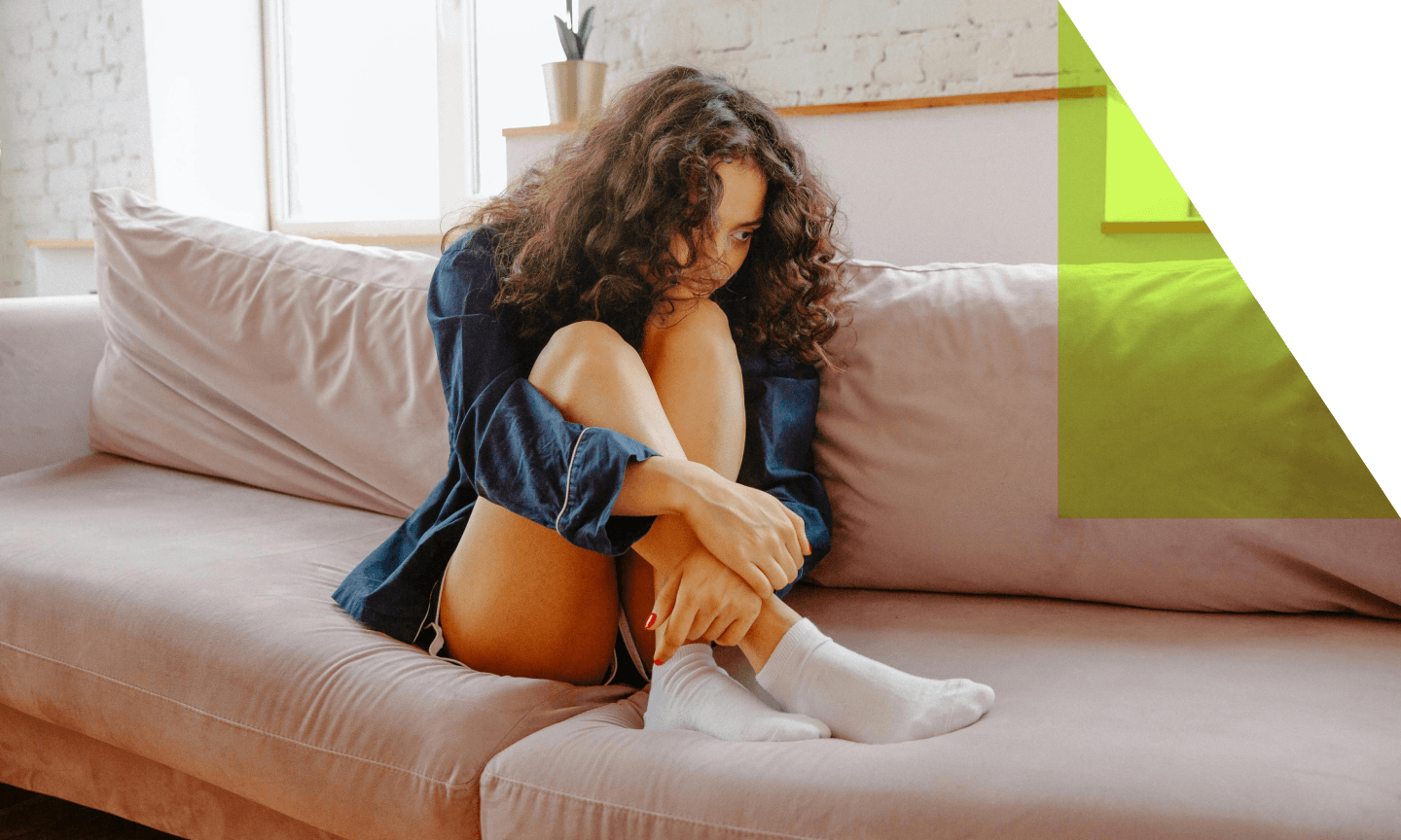 woman with back pain on couch