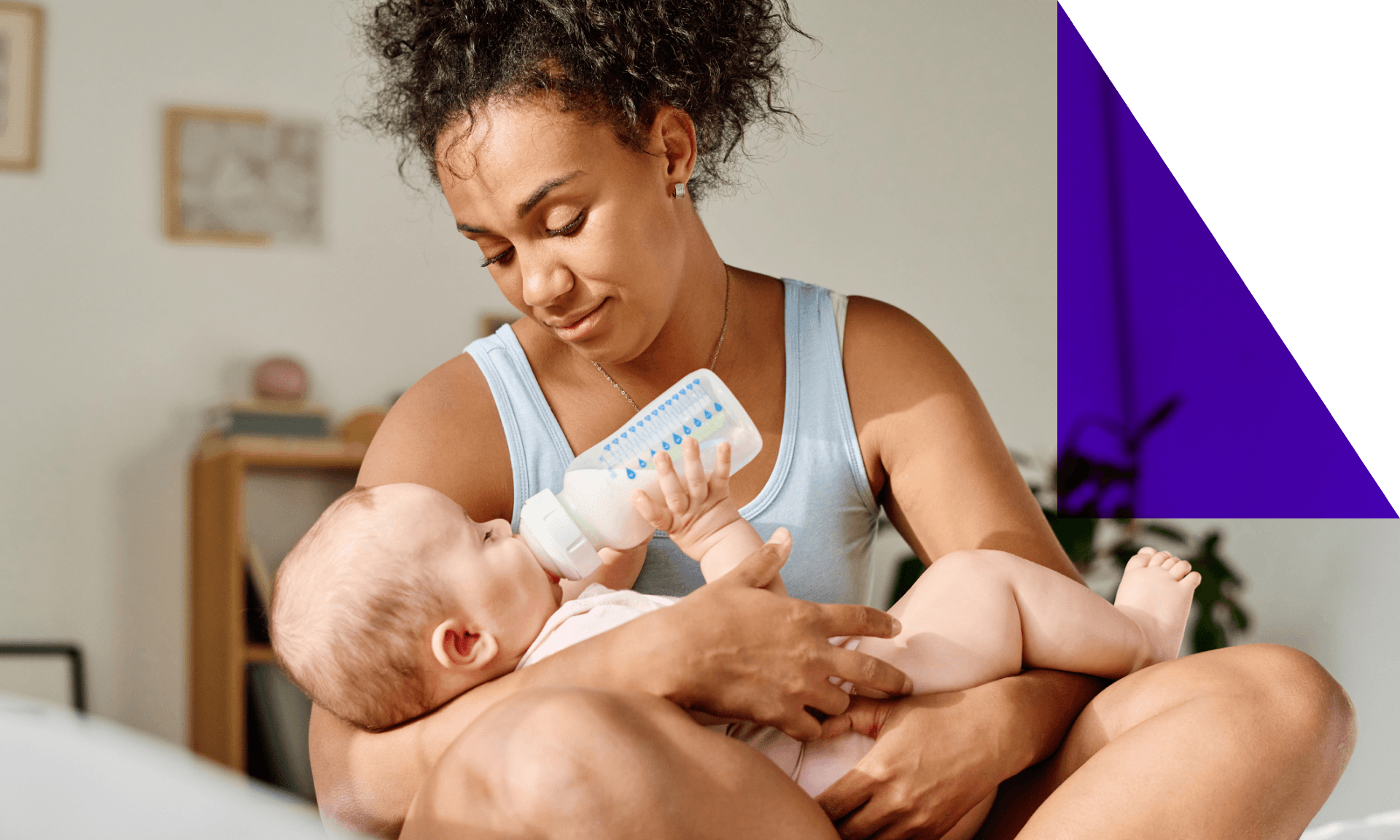 Image of a mother holding a baby with a bottle
