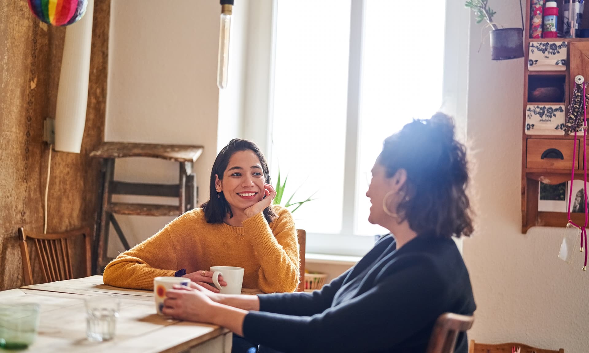 Two friends talking at a table